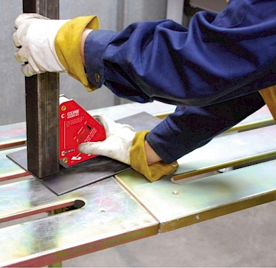 Worker using a welding clamp to secure metal